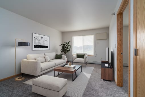 a living room with a white couch and a coffee table. Grand Forks Desoto Estates