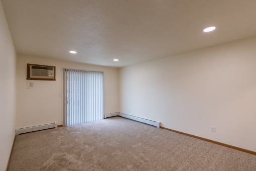 Grand Forks, ND Grandview Apartments. A living room with a glass sliding door.