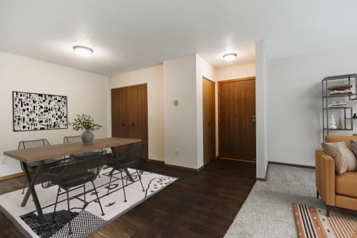 A dining room with a table and four chairs and the entry door in the background  at Harrison and Richfield, Grand Forks, North Dakota