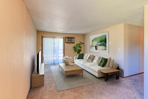 a living room with a white couch and a coffee table.  Grand Forks, ND Madison Apartments