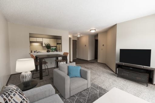 Grand Forks Primrose Apartments. A living room with a couch a chair and a tv