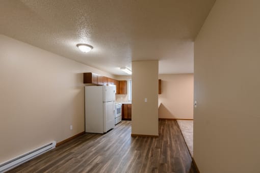 Grand Forks, ND Richfield Apartments. A dining room with a kitchen in the background.