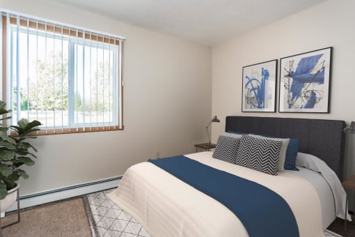 Grand Forks, ND Riverwood Apartments. A bedroom with a large bed and a window