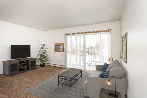 Grand Forks, ND Riverwood Apartments. A living room with a couch and a tv and a balcony