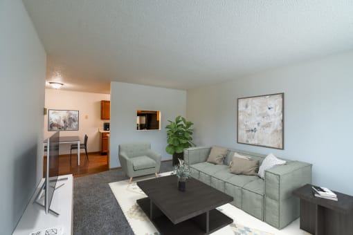 An open living room with a couch and a coffee table. Grand Forks, ND Southview Apartments.