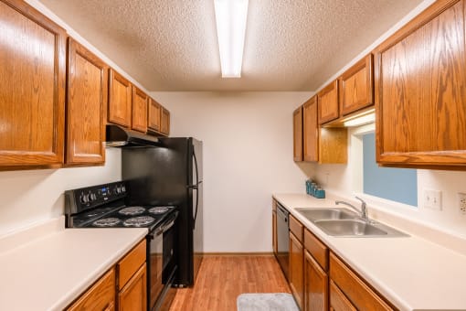 Grand Forks, ND Southview Apartments. A kitchen with black appliances.