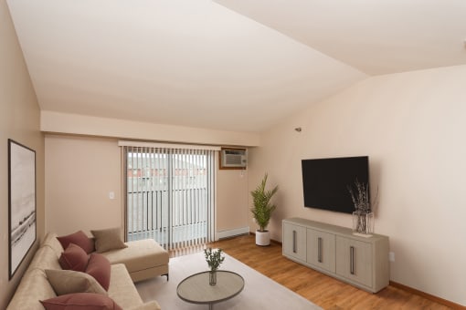 a living room with a couch and a tv on the wall  at Sterling Pointe, Grand Forks, ND