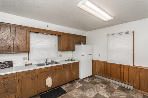 Grand Forks, ND Valley Home Duplex. a kitchen with white appliances and wooden cabinets
