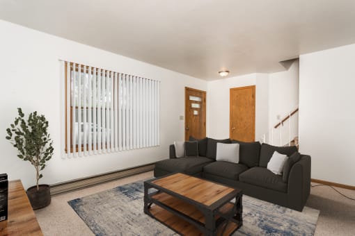 Grand Forks, ND Valley Home Duplex.  a living room with a black couch and a wooden coffee table