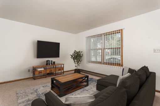 Grand Forks, ND Valley Home Duplex.  a living room with a couch and coffee table and a tv on the wall