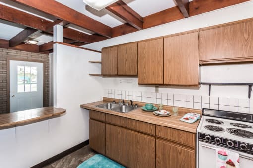Grand Forks, ND Washington Apartments. A kitchen with a stove and a sink