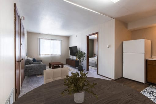 a living room with a dining room table and a kitchen