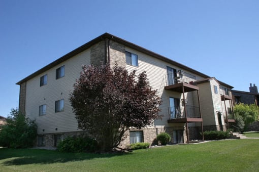an exterior of an apartment building.  Fargo, ND Hunters Run Apartments