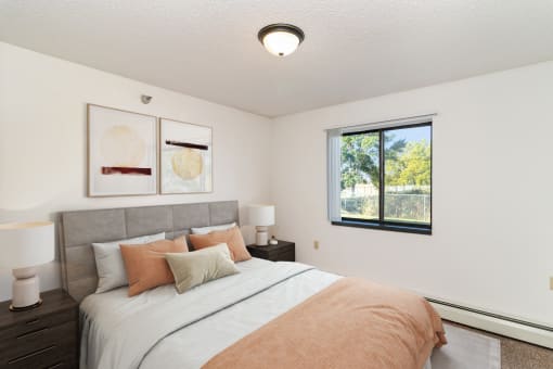 a bedroom with a bed and nightstands. Hutchinson, MN Deer Park Apartments