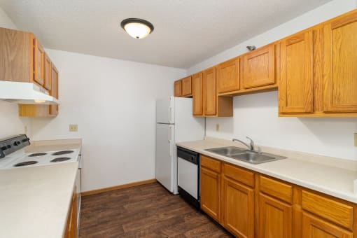 a kitchen with white appliances. Hutchinson, MN Deer Park Apartments
