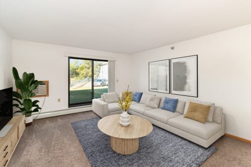 a living room with a couch and a coffee table. Hutchinson, MN Deer Park Apartments