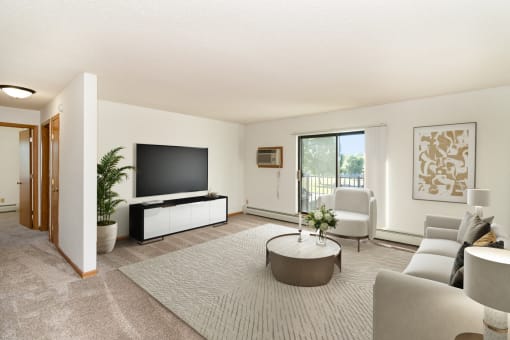 a living room filled with furniture and a large tv. Hutchinson, MN Deer Park Apartments