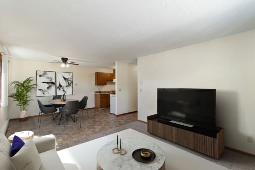 a living room with a couch and a table and a television. Hutchinson, MN Echo Manor Apartments