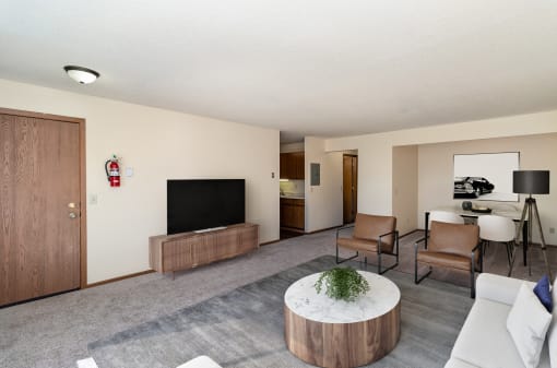 a living room with a couch and chairs and a television. Hutchinson, MN Twin Oaks