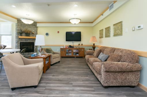 a community area with a tv and couches. Fargo, ND Sunrise North