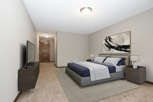 Georgetown on the River Apartments, Fridley, Minnesota. A bedroom with a bed and a tv.