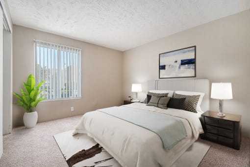 Omaha, NE Evergreen Terrace Apartments. Bedroom with a large white bed and a large window