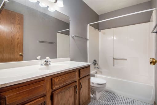 Omaha, NE Woodland Pines Apartments. A bathroom with a toilet sink and bathtub