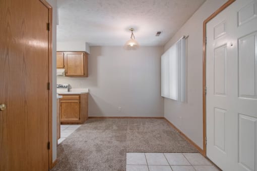 Omaha, NE Woodland Pines Apartments. A kitchen and living room with a white door
