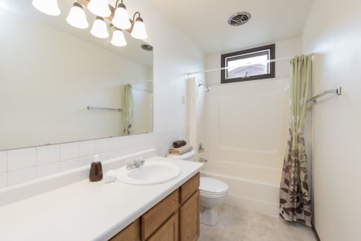 Bismarck, ND Riverpark Apartments. A bathroom with a toilet sink and bathtub  Riverpark Apartments | Bismarck, ND