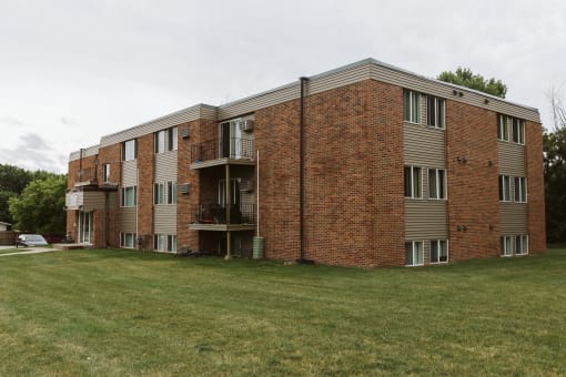 Grand Forks, ND Riverwood Apartments. A red brick apartment building with a green yard