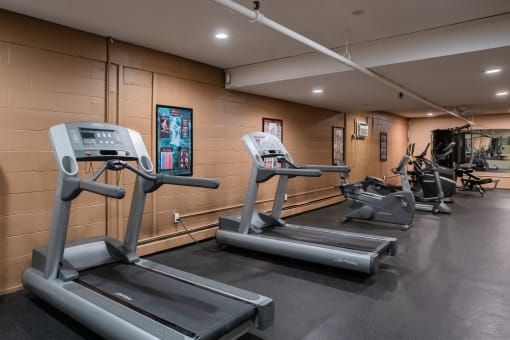 two treadmills and other exercise equipment in the gym of a building. Roseville, MN Rosedale Estates Apartments
