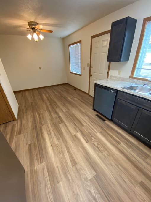an empty kitchen with wood flooring in an empty house. Fargo, ND Sheyenne Terrace