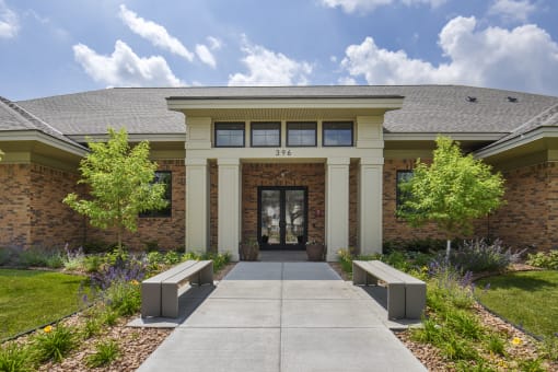 a building with a walkway and benches in front of it