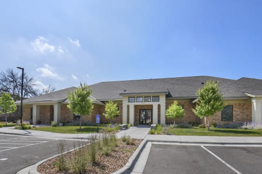 a large brick building with a parking lot and a driveway
