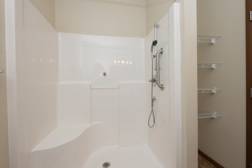 a bathroom with a shower and a bath tub. Fargo, ND North Sky Apartments