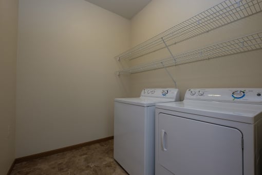 the washer and dryer in the laundry room. Fargo, ND North Sky Apartments