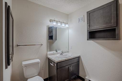a bathroom with a sink and toilet. Fargo, ND Lake Crest Apartments