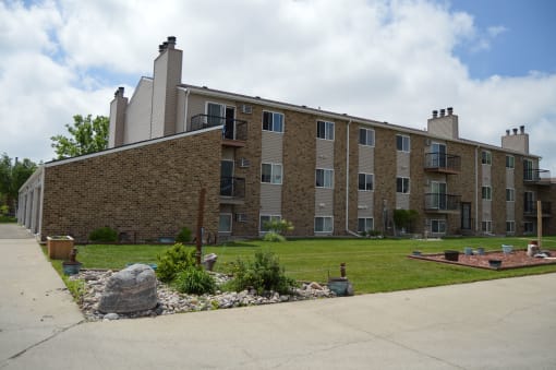 An exterior of a brick apartments building. Windgate Apartments | Fargo, ND