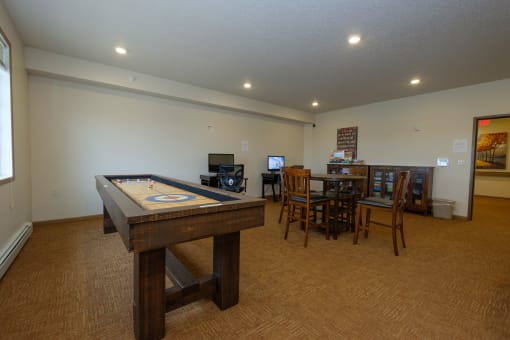 a game room with a pool table. Fargo, ND North Sky Apartments