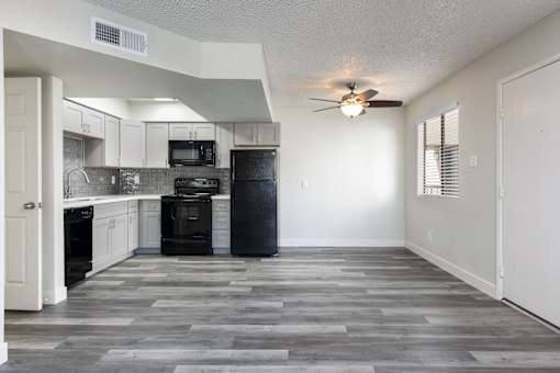 A kitchen with a black oven and microwave.
