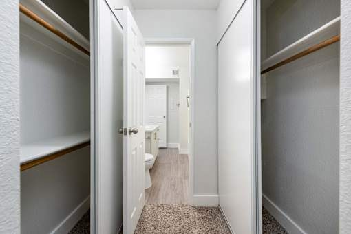 a bathroom with a toilet and a walk in closet