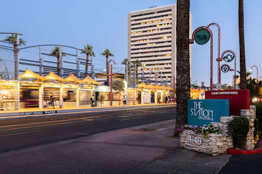 A street view of a city with a sign that reads "The Station".