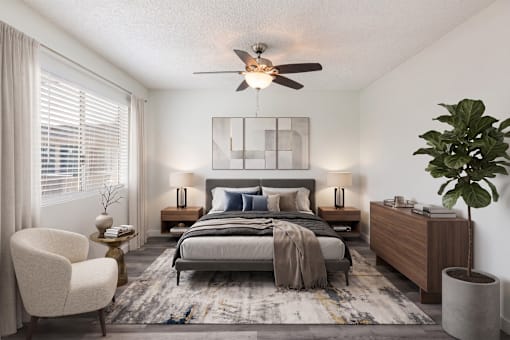 A bedroom with a bed, nightstand, and chair.
