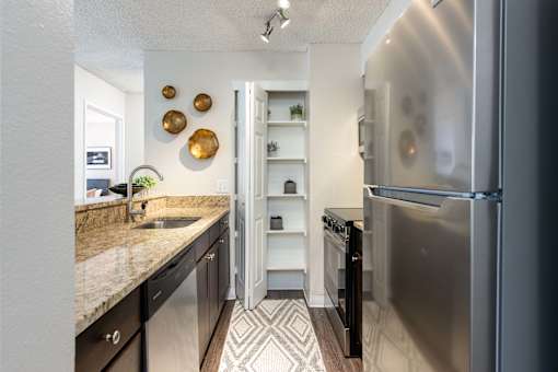 a kitchen with stainless steel appliances and granite counter tops