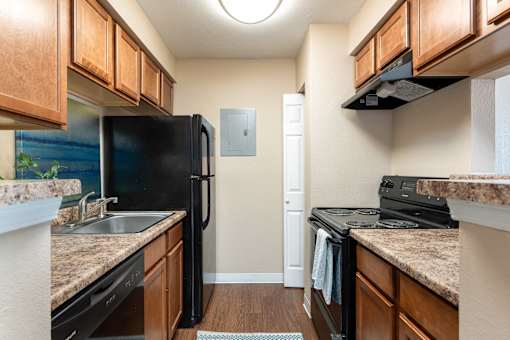 a kitchen with black appliances and granite counter tops