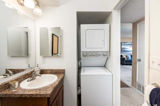 a bathroom with a sink and a washer and dryer