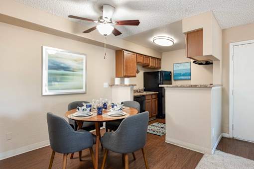 an open kitchen and dining room with a table and chairs