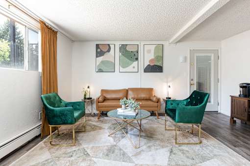 a living room with two green chairs and a brown couch