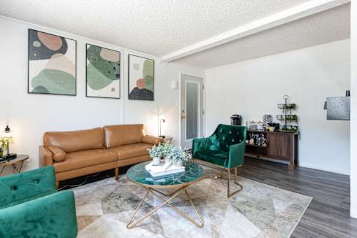 a living room with green chairs and a brown couch