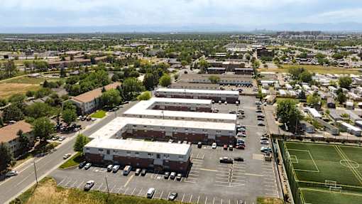 an aerial view of a large industrial building in a parking lot
